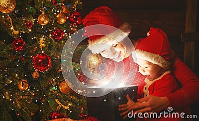 Happy family mother and baby with magical Christmas gift Stock Photo