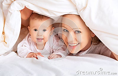 Happy family. Mother and baby playing under blanket Stock Photo