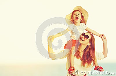 Happy family mother and child daughter on beach at sunset Stock Photo