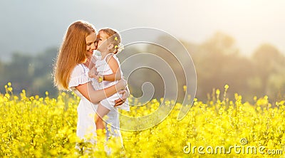 Happy family mother and child daughter embrace on nature in sum Stock Photo