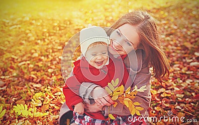 Happy family: mother and child little daughter play cuddling on autumn Stock Photo