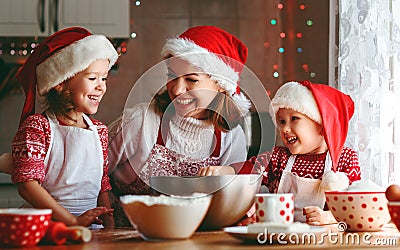 Happy family mother and children bake cookies for Christmas Stock Photo