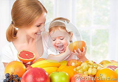 Happy family mother and daughter little girl, eat healthy vegetarian food, fruit Stock Photo