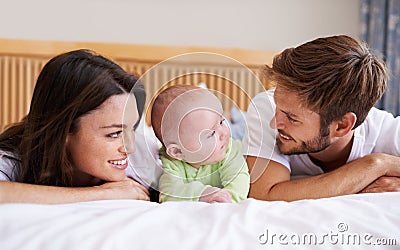 Happy family, mother and father with baby on bed for love, care and fun quality time together at home. Parents, cute Stock Photo