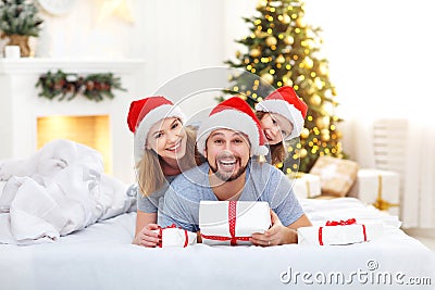 Happy family mother father and child on Christmas morning in bed Stock Photo