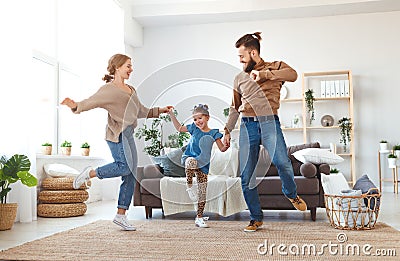 Happy family mother father and child daughter dancing at home Stock Photo