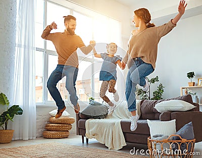 Happy family mother father and child daughter dancing at home Stock Photo