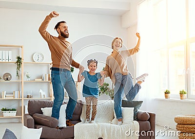 Happy family mother father and child daughter dancing at home Stock Photo