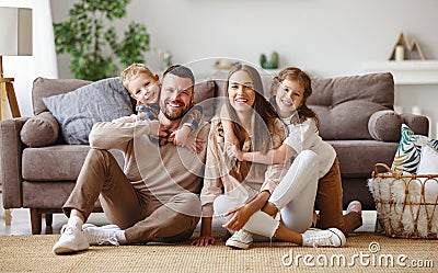 Happy family mother father and children at home on couch Stock Photo