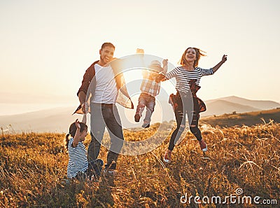 Happy family: mother, father, children son and daughter on sunset Stock Photo