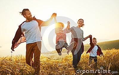 Happy family: mother, father, children son and daughter on sunset Stock Photo