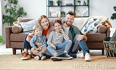 Happy family mother father and kids at home on couch Stock Photo