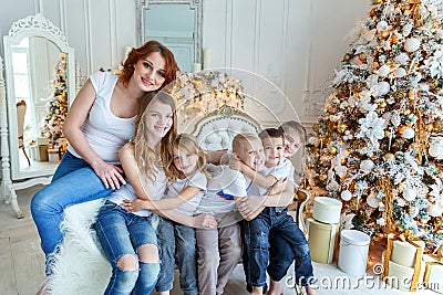 Mother and five children near Christmas tree at home Stock Photo