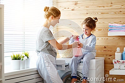 Happy family mother housewife and child in laundry with washin Stock Photo