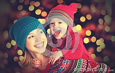 Happy family mother and little daughter playing in the winter for Christmas Stock Photo