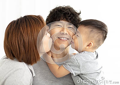 family mother and son kissing father Stock Photo