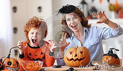 Happy family mother and son laughing and making scary faces during Halloween celebration Stock Photo