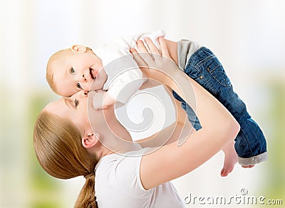 Happy family. Mother throws up baby, playing Stock Photo