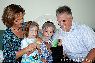 Family playing with hand puppets Stock Photo