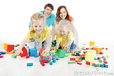 Happy family. Parents with two kids playing toys blocks Stock Photo