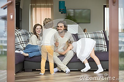 Happy family playing at home, kids having fun with parents Stock Photo