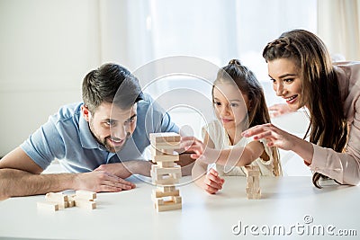 Happy family playing jenga game at home Stock Photo