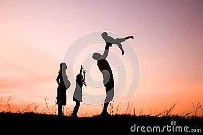 Happy family playing on nature summer silhouette Stock Photo