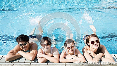 Happy family playing in swimming pool Stock Photo