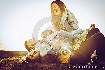 Happy family playing together on grass. Stock Photo