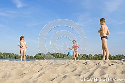 Happy family plays beach volleyball. Healthy lifestyle Stock Photo