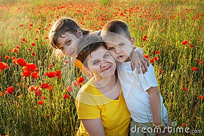 Happy family on the poppy field Stock Photo