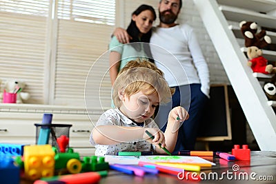 Happy family portrait having fun together. Father mother and child son drawing. Kid learning painting, little artist Stock Photo