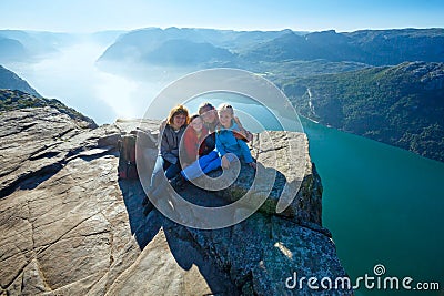Happy family on Preikestolen massive cliff top (Norway) Stock Photo
