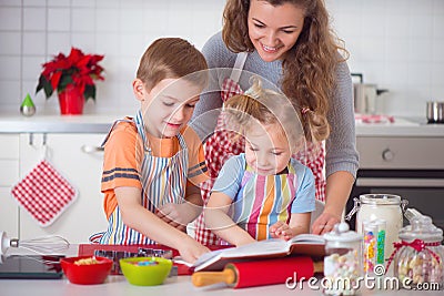 Happy family preparing cookies for Christmas eve Stock Photo