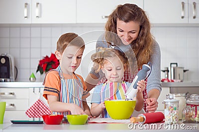 Happy family preparing cookies for Christmas eve Stock Photo