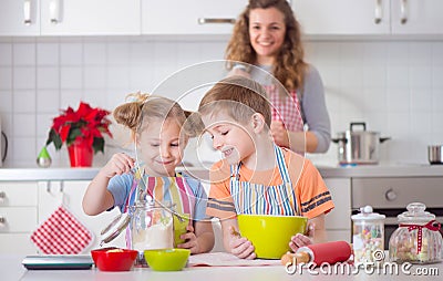 Happy family preparing cookies for Christmas eve Stock Photo