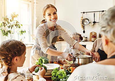 Happy family preparing healthy lunch together Stock Photo