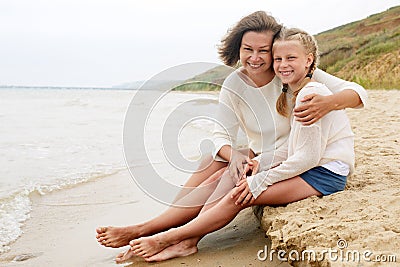 Happy family resting on a sandy beach Stock Photo