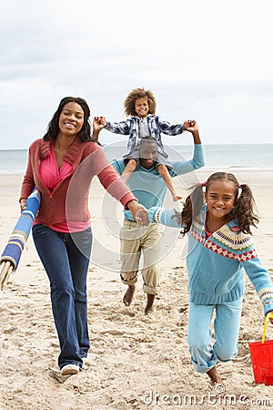 Happy family running on beach Stock Photo