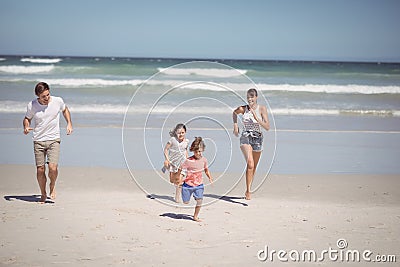 Happy family running at beach Stock Photo