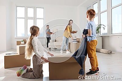 Happy family settling into new house and unpacking boxes. Moving day Stock Photo