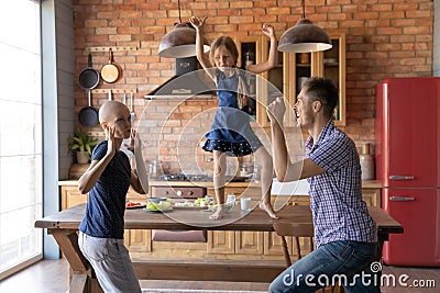 Happy family with sick mother dance in kitchen Stock Photo