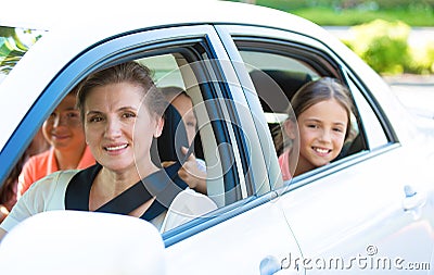 Happy family sitting in a car Stock Photo