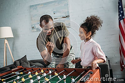 Happy family of soldier father and african american daughter playing Stock Photo