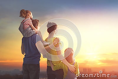 Happy family at sunset Stock Photo