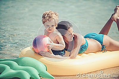 Happy family swimming on an air mattress, mother and chil together. Stock Photo