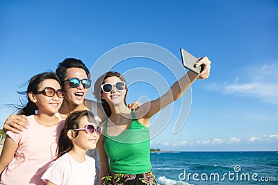 Happy family taking a selfie at the beach Stock Photo