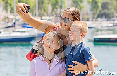 Happy family taking selfie. Mom and her kids take a picture together Stock Photo