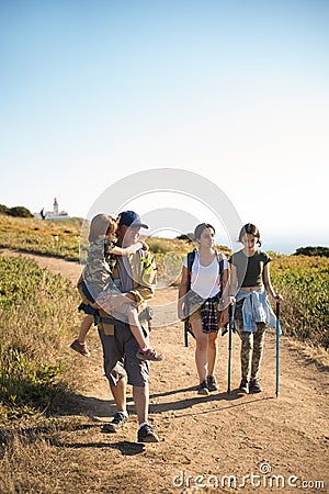Happy family trekking in mountains in summer Stock Photo