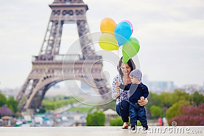 Happy family of two with bunch of colorful balloons in Paris Stock Photo